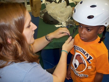 Picture of a Helmet Safety tutorial at a community Bike-a-thon - idea of a 9/11 community activity